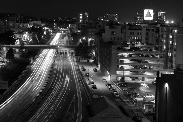 2015 GP Photo Contest Finalist black and white phot of the MAss turnpicke at night with the citgo sign in the distance