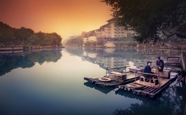 2015 GP Photo Contest 1st place winner 2 men sitting on a wooden raft on a river in Guilin china