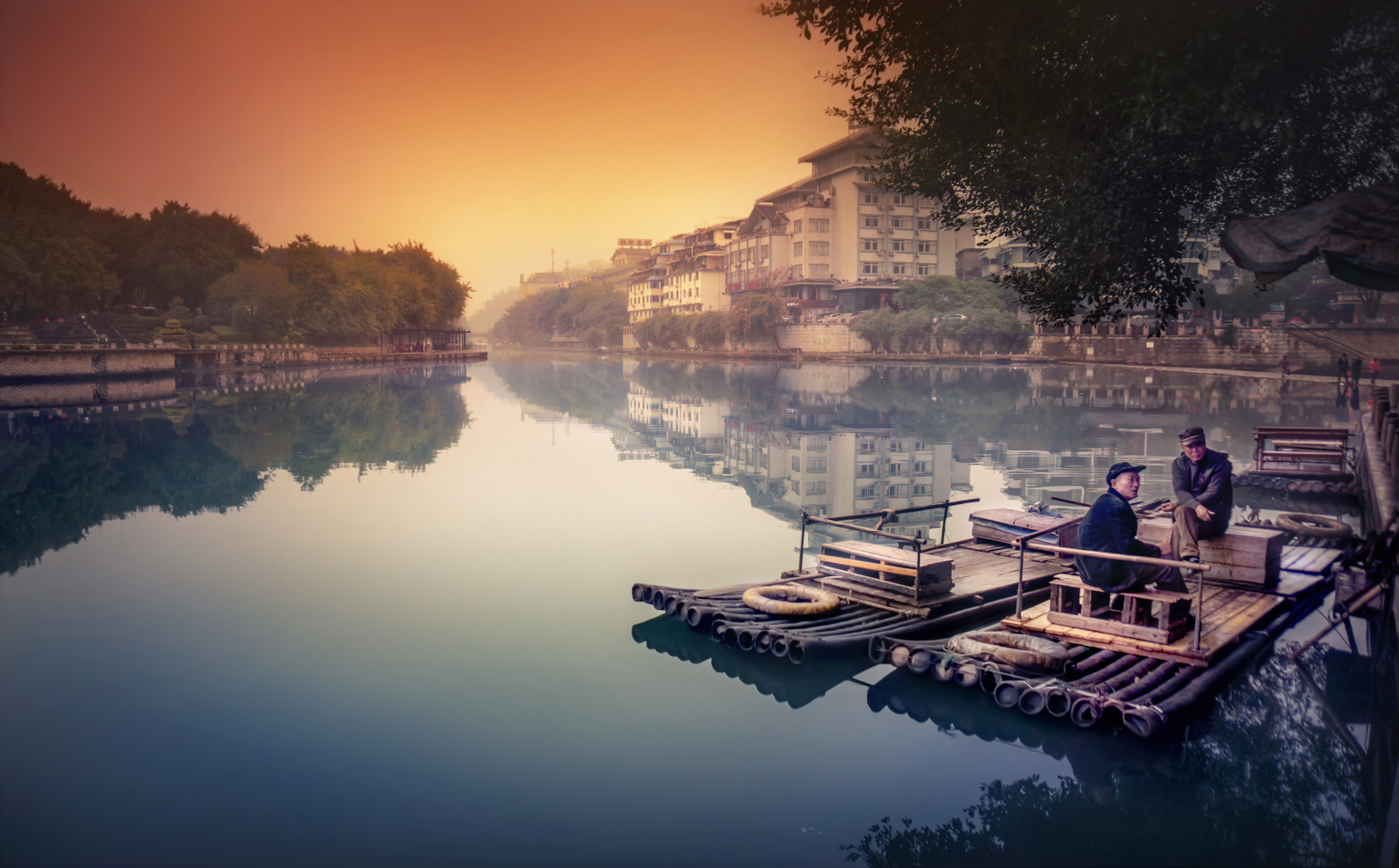 2015 GP Photo Contest 1st place winner 2 men sitting on a wooden raft on a river in Guilin china