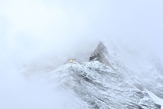 2018 GP Photo Contest 3rd place winner small unmarked house is nestled in the snowy peak of the swiss alps