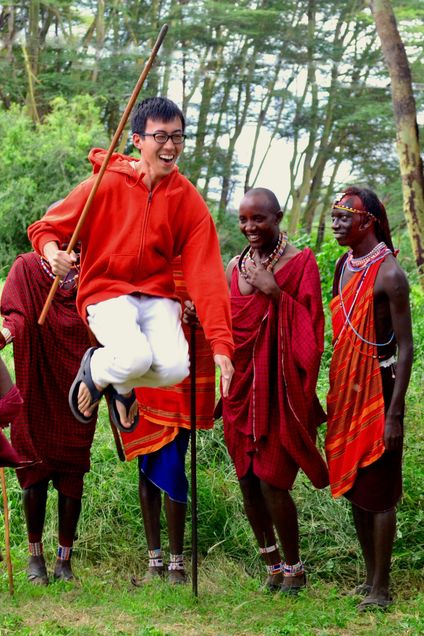 2016 GP Photo Contest Finalist man jumping with a stick in front of smiling tribesmen in Kenya