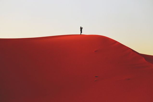 2018 GP Photo Contest Finalist man standing a top a red sand dune