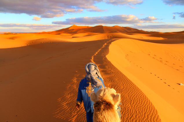 First place People category 2020 GP Photo Contest Man walking his camel in the desert