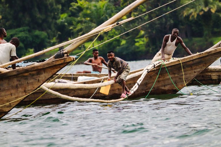 Finalist 2023 GP Photo Contest boy walking on tied branches between boats in Rwanda