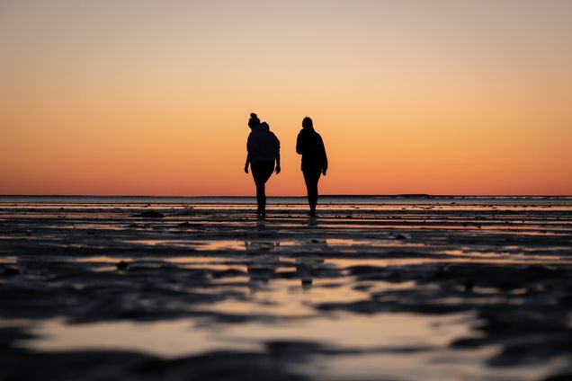 2021 GP photo contest finalist two women walking on a beach at sunset