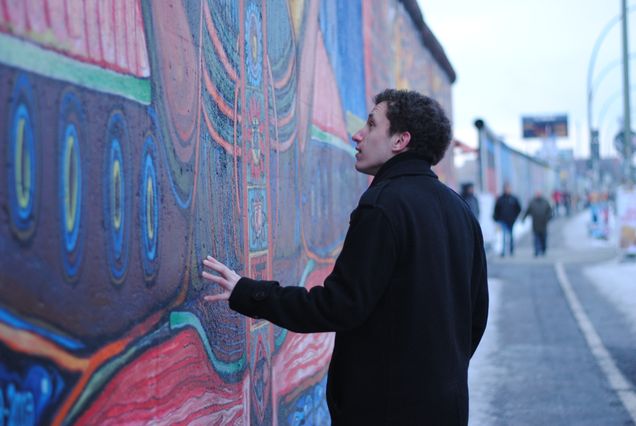 2013 GP Photo Contest 1st place winner Man looking at a mural on a wal on a city street