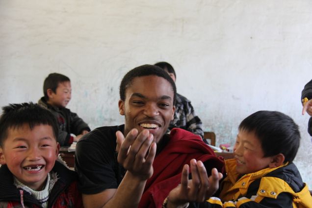 2013 GP Photo Contest 2nd place winner BU student laughing with children in shnaghai china play