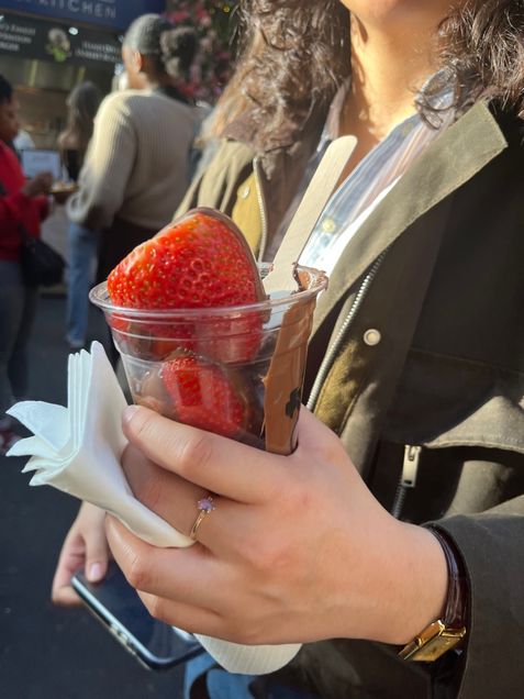 photo of roommate holding cup f chocolate-covered strawberries