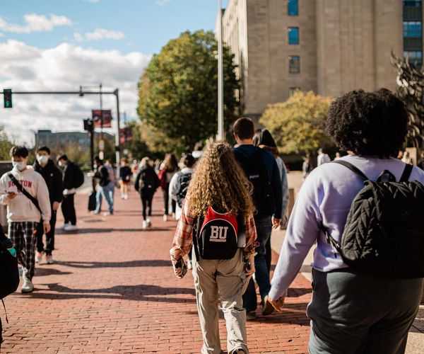 Students walk down BU campus on Commonwealth Ave.