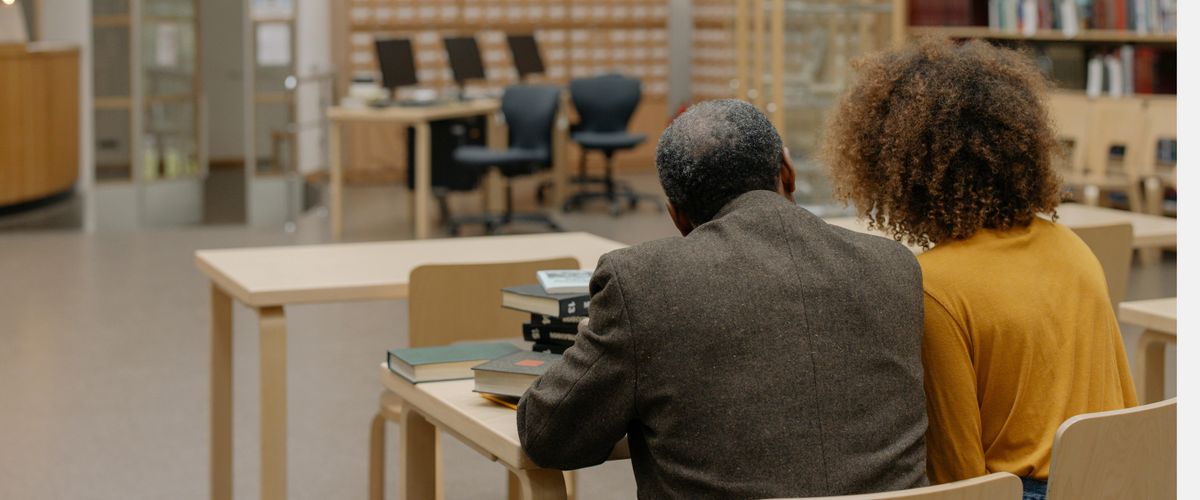 Student and her and instructor work together at a desk.