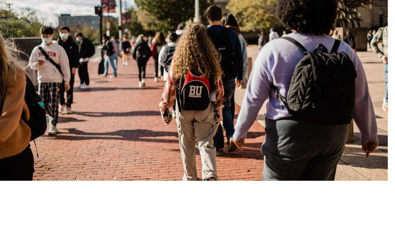 Students walk down BU campus on Commonwealth Ave.