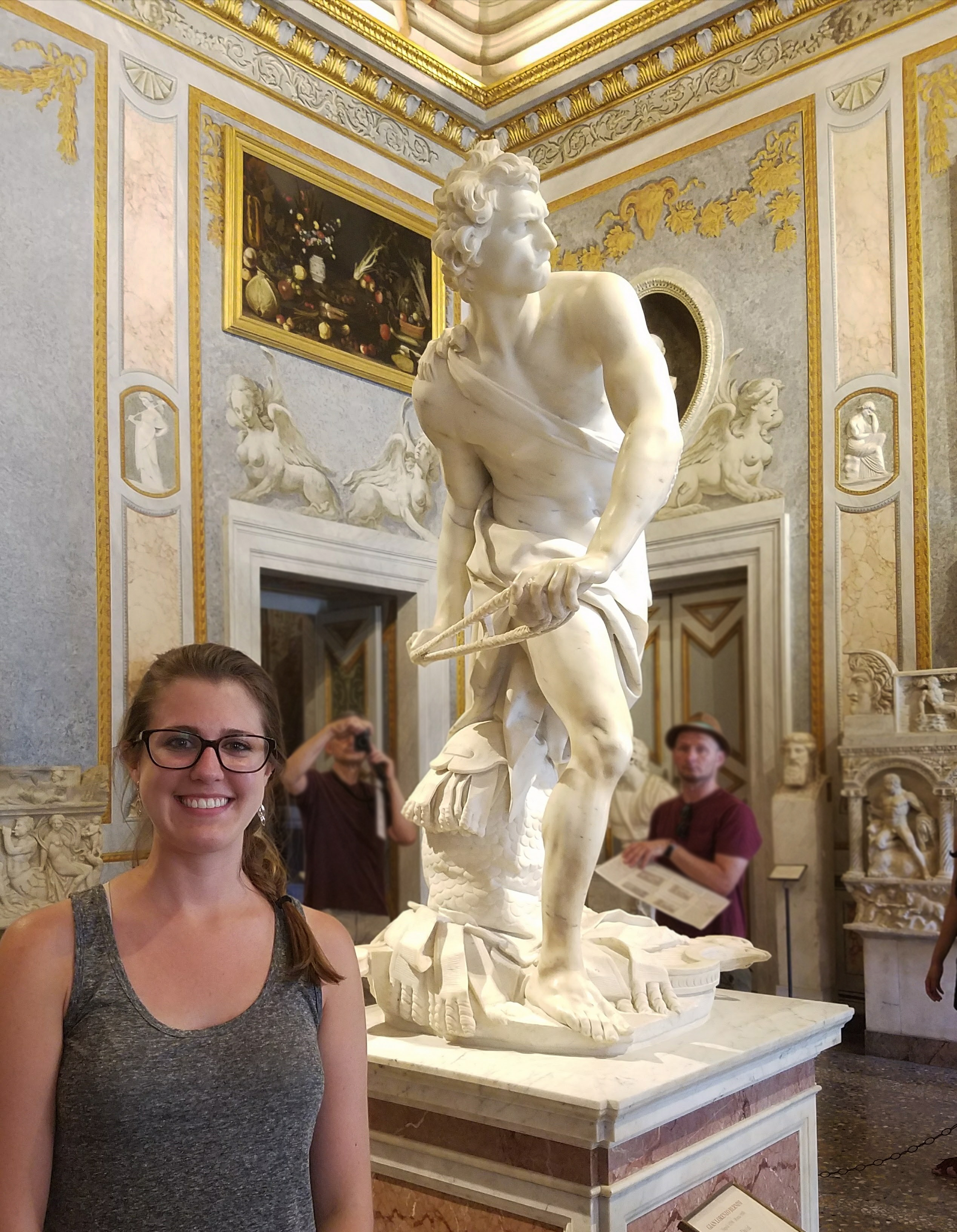 Jessica Zack standing in front of Bernini's marble statue of David at Galleria Borghese, Rome.