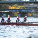 Photo: A group of BU crew members rowing on the Charles River.
