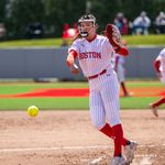 Photo: A female BU softball player pitching a ball during a game