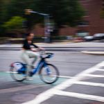 Photo: An artistically blurred photo of someone on a bicycle in a bike lane on Commonwealth Avenue in Boston