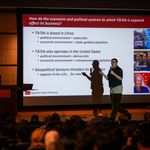 Photo: Jeffrey Furman, a Questrom School of Business professor at Boston University, standing in front of a screen that has the text "How do the economic and political systems to which TikTok is exposed affect its business?" during a class