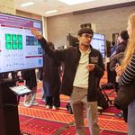 Photo: A male BU student standing in front of a board presenting their research. The board reads "Investigating the Role of Bcl11b on Embryonic Cardiac Development & Function in Xenopus laevis"
