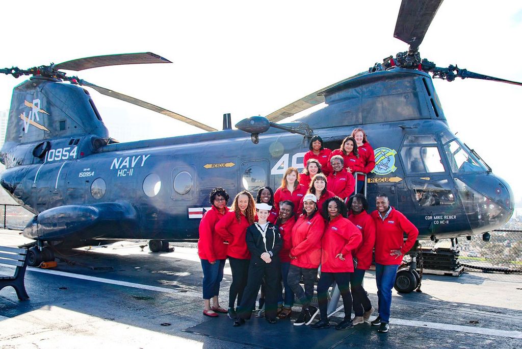 Photo: A group of women veterans in front of a helicopter