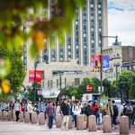 Photo: Commonwealth Avenue on BU's campus on a sunny day with many students walking