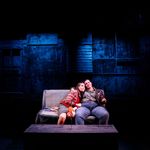 Photo: Two women on a stage sitting on a couch