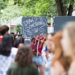 Photo: Large crowd of people in front of a sign that says "Draw Something"