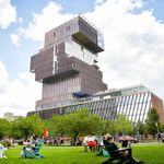 Photo: Boston University's COM Lawn filled with students on a sunny day. The Center for Computing and Data Sciences on Boston University's campus is visible in the background