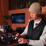 Photo: A man in a beanie pours an espresso