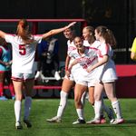 Photo: Women's soccer players embrace during a game at Boston University