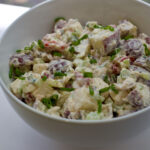Photo: a large white bowl filled with potato salad