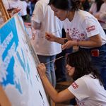 Photo: BU students painting a mural of campus at the George Sherman Union