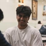 Photo: Three BU students sitting at a table and laughing together