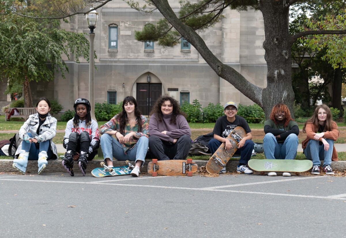 Photo: The BU Girls' Skateboarding Club poses for a photo along the BU Beach, an outdoor area where BU students can relax and unwind outside.