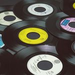 Photo: A stock photo of records piled on top of each other.