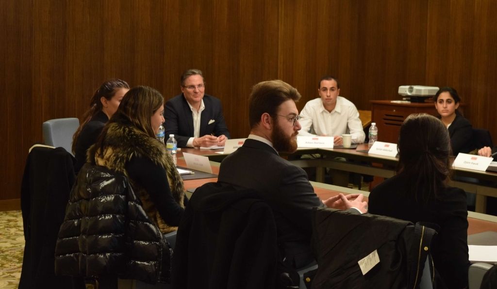 Faculty and students speaking in a conference