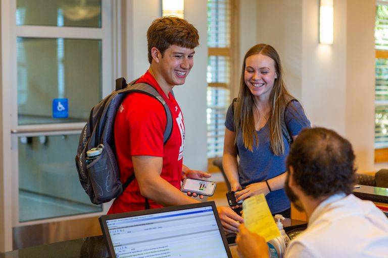 photo of students checking in at front desk