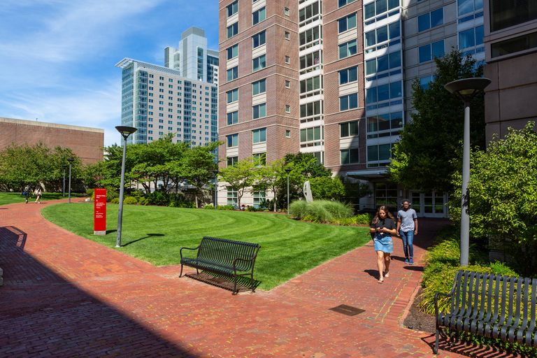 photo of students walking thru student village