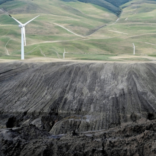 Coal pit with wind turbines in background