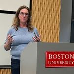 Emily Ryan lectures at a podium.