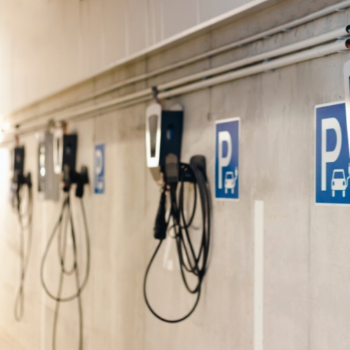 Electric vehicle chargers in a parking lot.