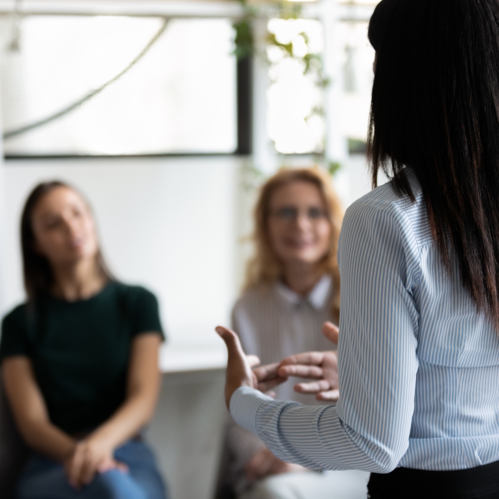 A professional talking to a group of people.