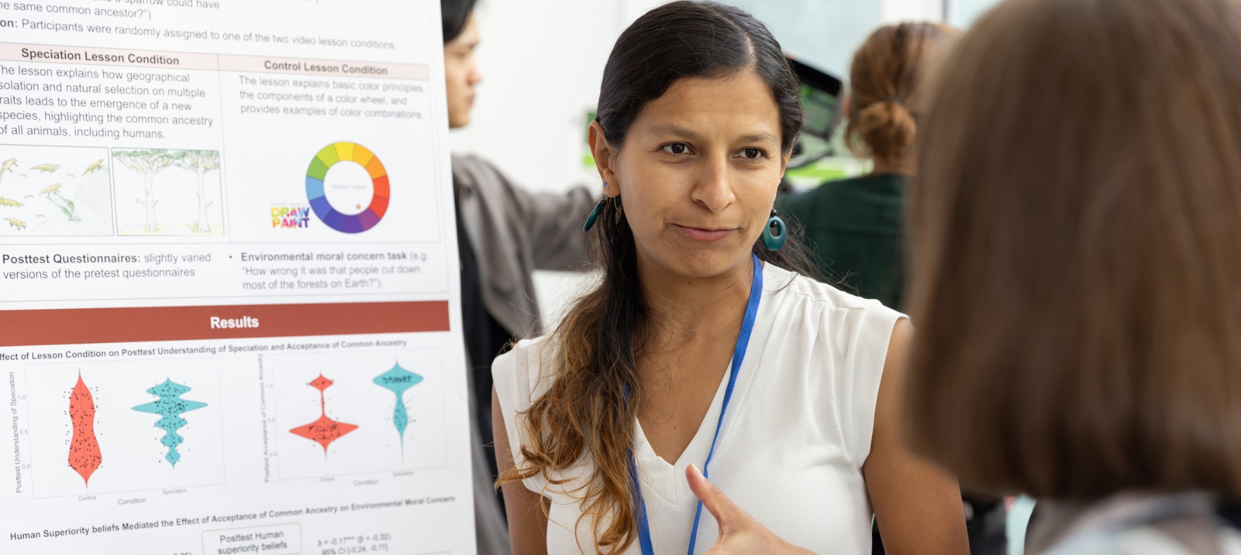 Professional next to resarch poster at a conference.