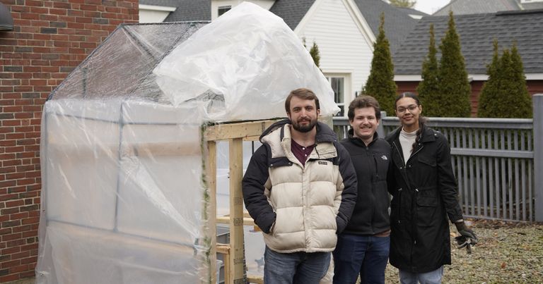 Students pose in front of their Campus Climate Lab project.