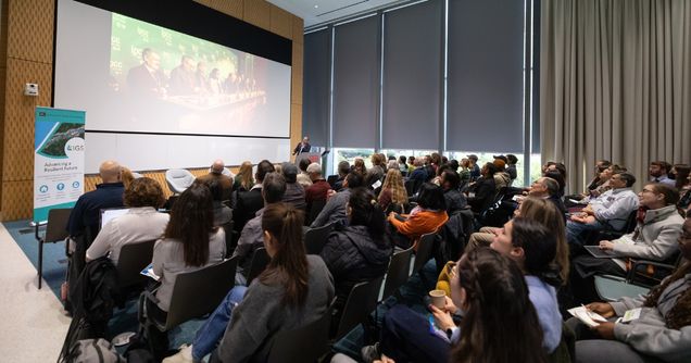 Benjamin Sovacool speaks to a crowded lecture hall of people.