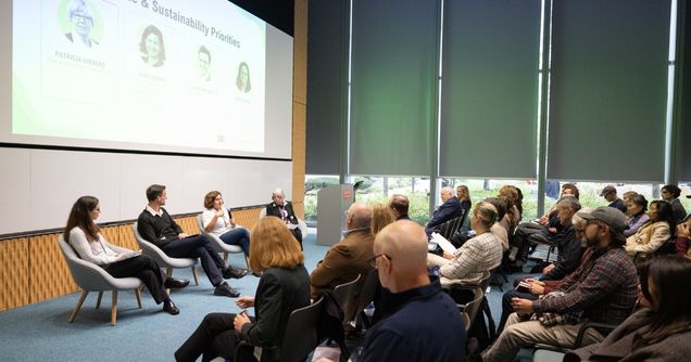 IGS fireside chat panelists seated in front of event attendees.