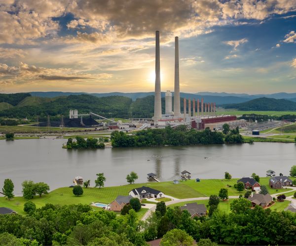 A power plant beside a suburban neighborhood.