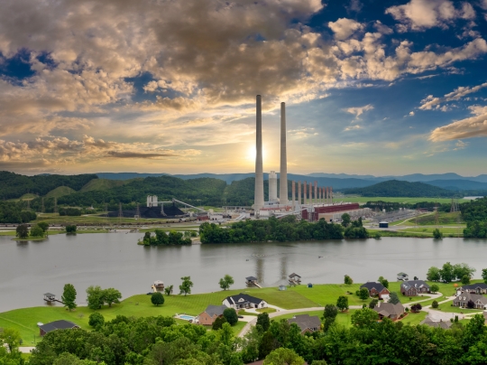 Thermal power plant polluting air nearby houses.