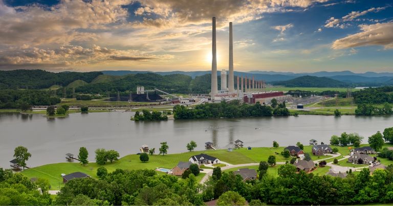 A power plant beside a suburban neighborhood.