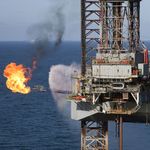 Offshore oil rig with gas flaring.