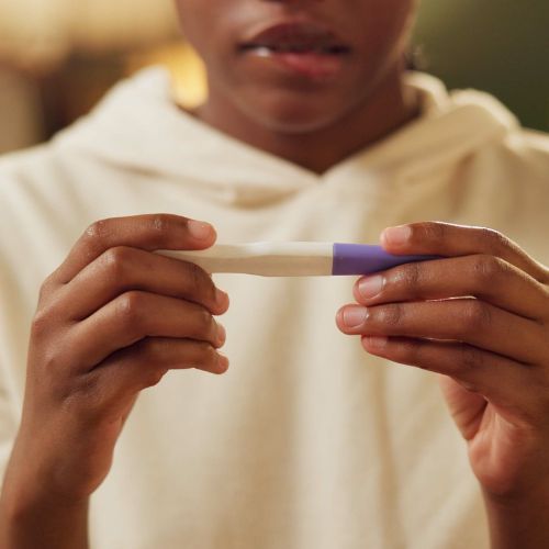 A woman looks at a pregnancy test.