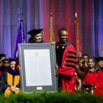 Antoinette Leatherberry, Chair of the Governance Committee on the Board of Trustees presents Melissa Gilliam with the University Charter in a frame